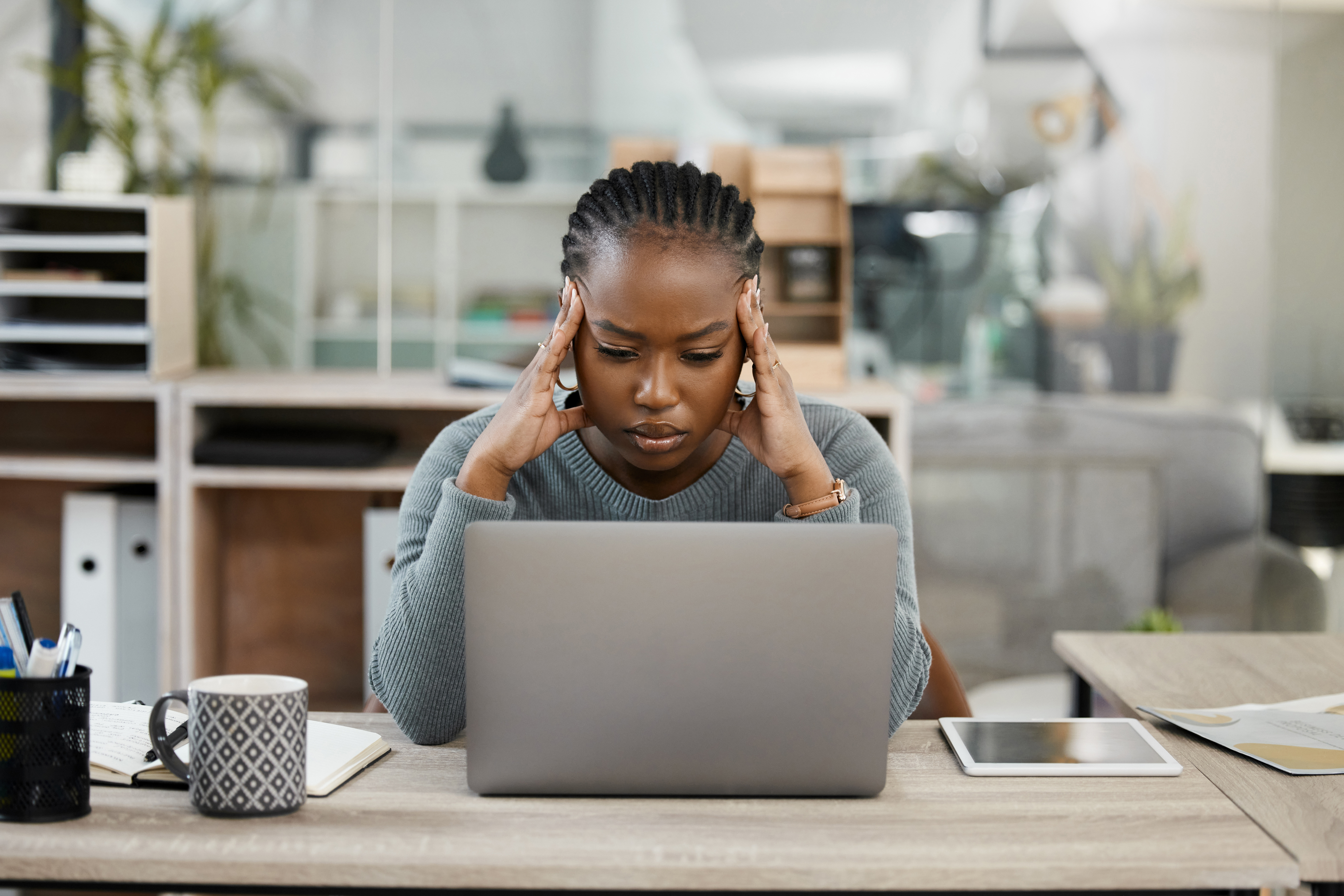 Business woman, laptop and headache in stress, burnout or depression in doubt, fail or mistake at office.